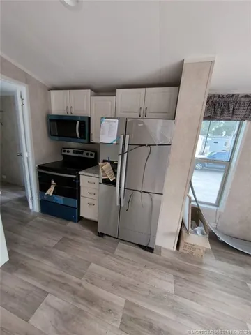 a kitchen with stainless steel appliances a stove a refrigerator and a sink