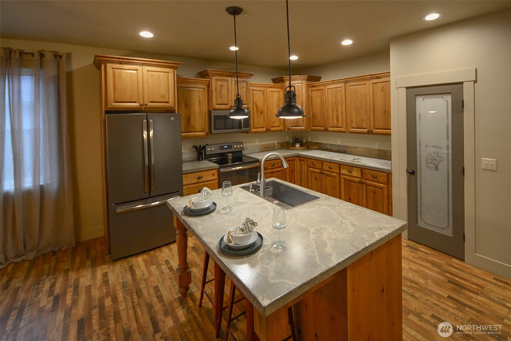 259 Parkside Loop Chehalis, WA 98532 - Photo 10 of 39 a kitchen with kitchen island white cabinets and refrigerator