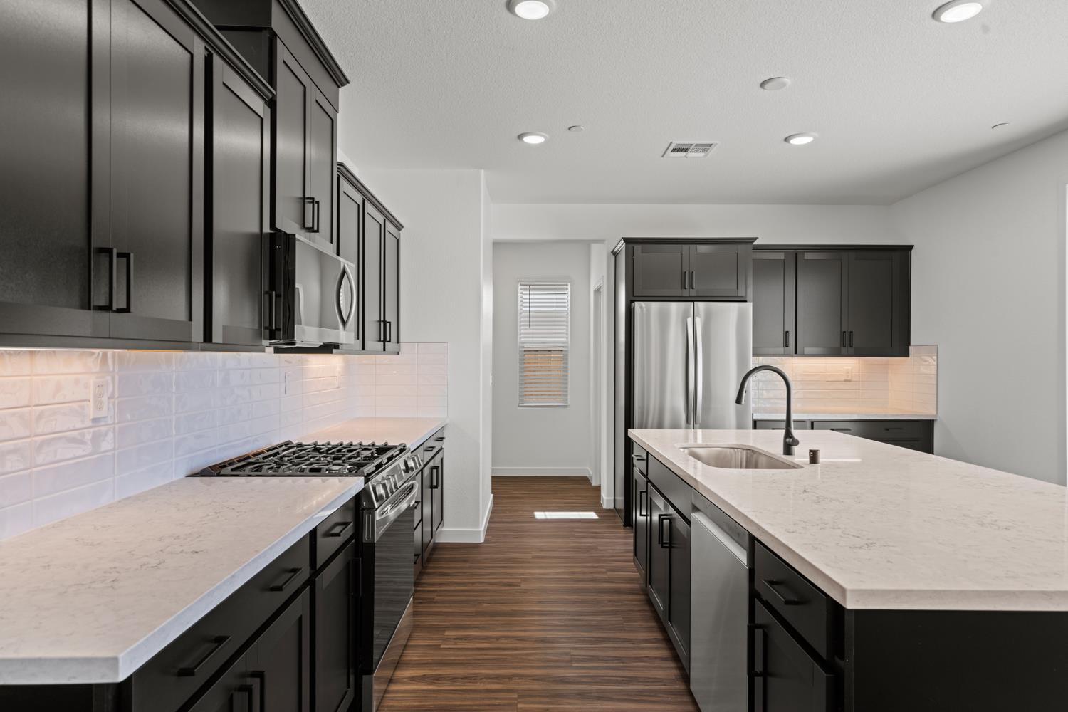1034 Slalom Way Lincoln, CA 95648 - Photo 4 of 15 a kitchen with stainless steel appliances granite countertop a sink stove and refrigerator