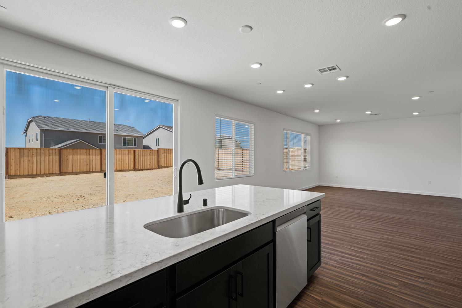 1034 Slalom Way Lincoln, CA 95648 - Photo 5 of 15 a kitchen with kitchen island a sink and wooden floor