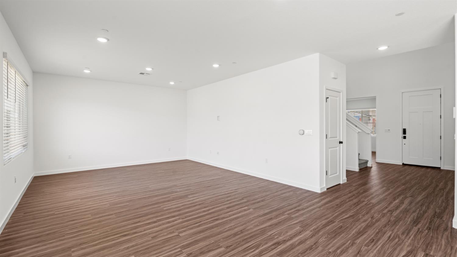 1034 Slalom Way Lincoln, CA 95648 - Photo 6 of 15 an empty room with wooden floor and entrance to ceiling window