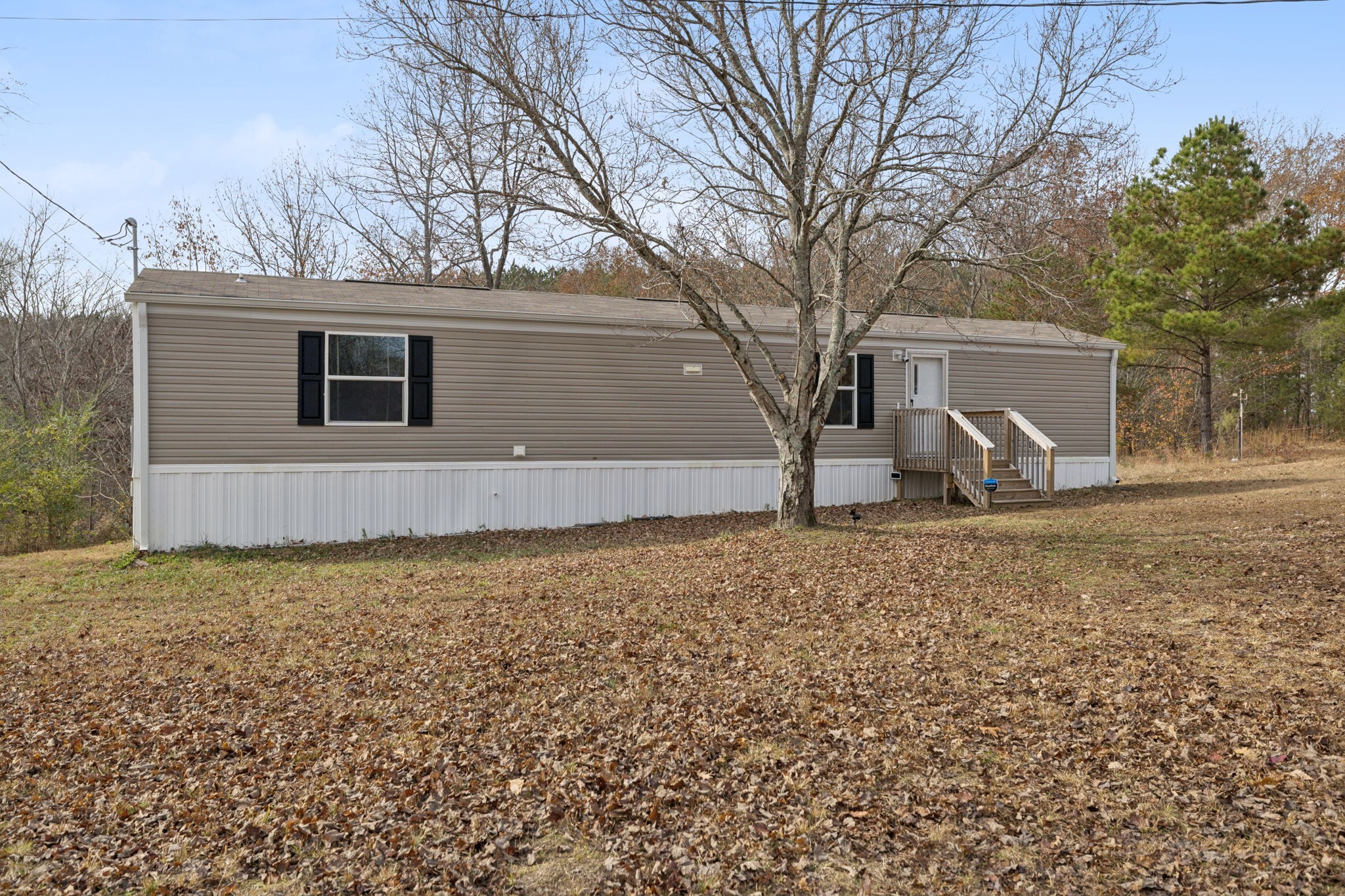 108 Lyell Road Hohenwald, TN 38462 - Photo 1 of 28 a backyard of house with garden