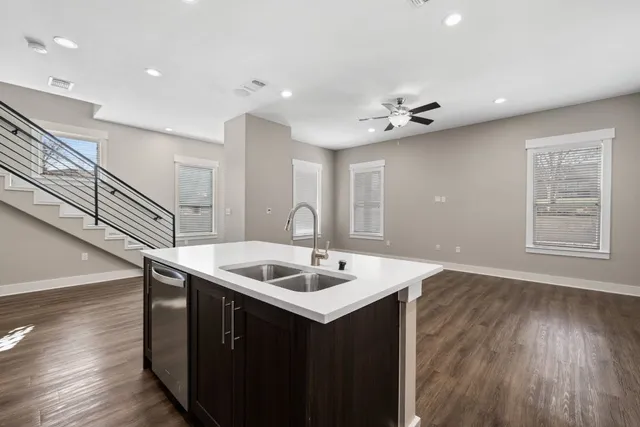 a kitchen that has a sink a microwave oven a counter top space and cabinets