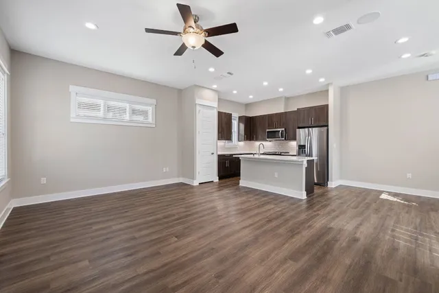 a view of kitchen with granite countertop cabinets and wooden floor