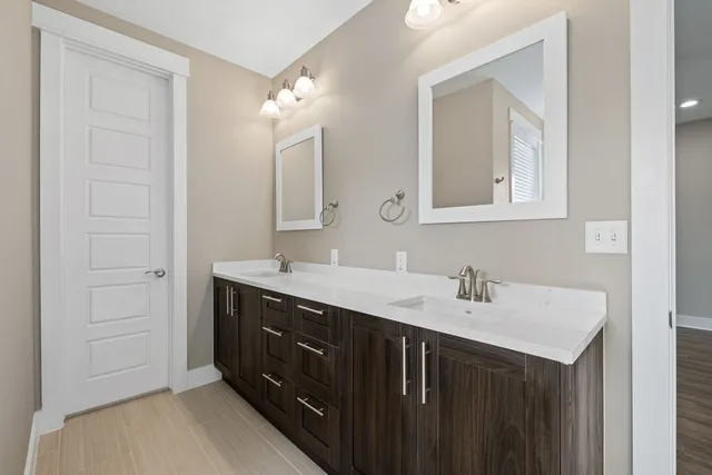 a bathroom with a sink vanity and mirror
