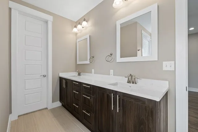 a bathroom with a sink vanity and mirror