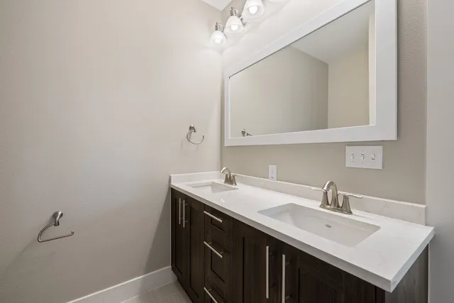 a bathroom with a sink vanity and a mirror