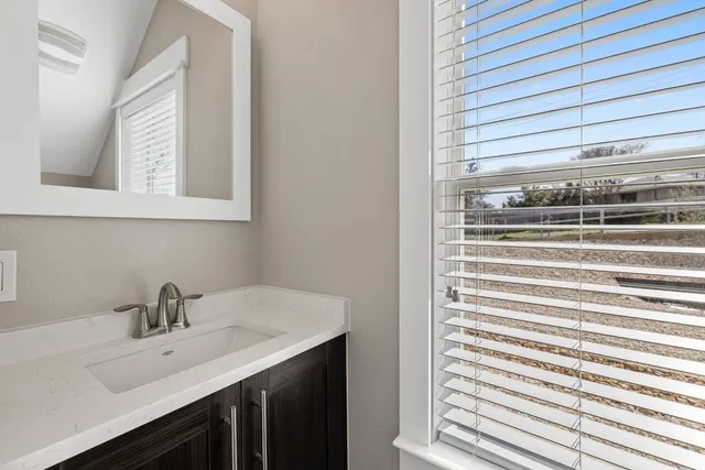 a bathroom with a sink and a window