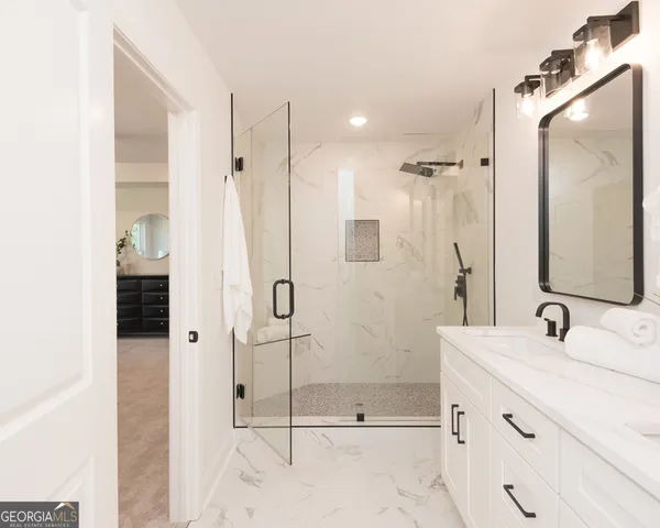 a bedroom with a large bed and a ceiling fan