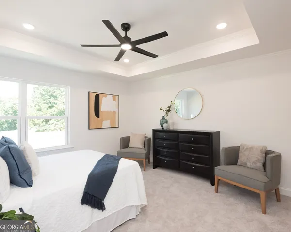 a spacious bedroom with bed and a couch