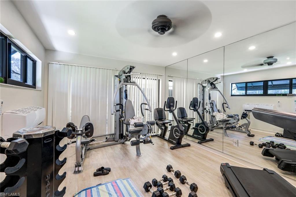 637 Beachwalk Circle, Unit E203 Naples, FL 34108 - Photo 22 of 30 a view of a room with gym equipment