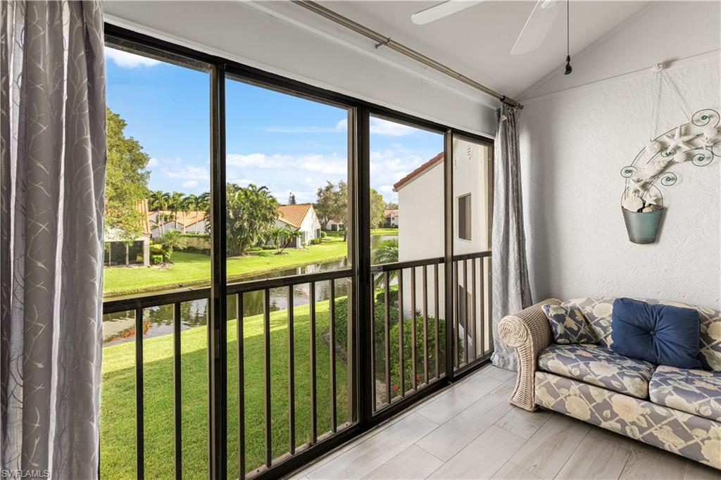 637 Beachwalk Circle, Unit E203 Naples, FL 34108 - Photo 5 of 30 a living room with furniture and a large window