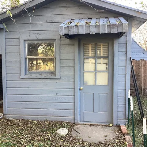 a front view of a house with a wooden fence