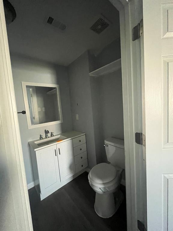 108 North Ash Street Springtown, TX 76082 - Photo 14 of 22 a bathroom with a toilet a sink and mirror