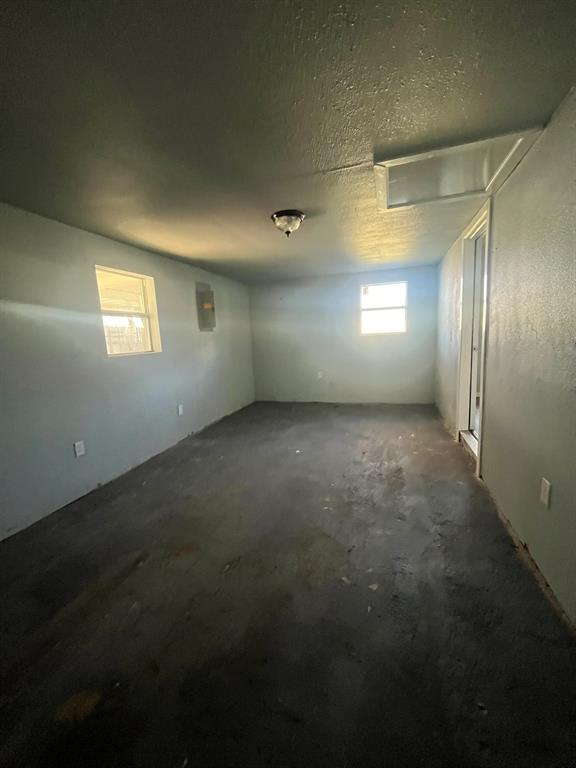 108 North Ash Street Springtown, TX 76082 - Photo 16 of 22 an empty room with windows and brick walls