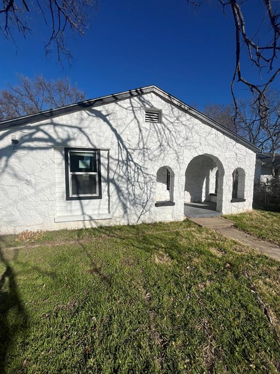 108 North Ash Street Springtown, TX 76082 - Photo 22 of 22 a front view of a house with garden