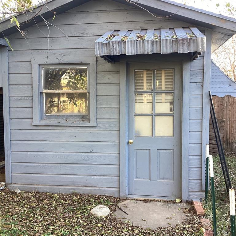 108 North Ash Street Springtown, TX 76082 - Photo 3 of 22 a front view of a house with a wooden fence