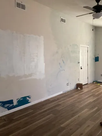 a view of wooden floor and windows in a room