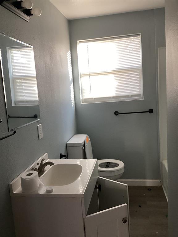108 North Ash Street Springtown, TX 76082 - Photo 5 of 14 a bathroom with a sink and a toilet