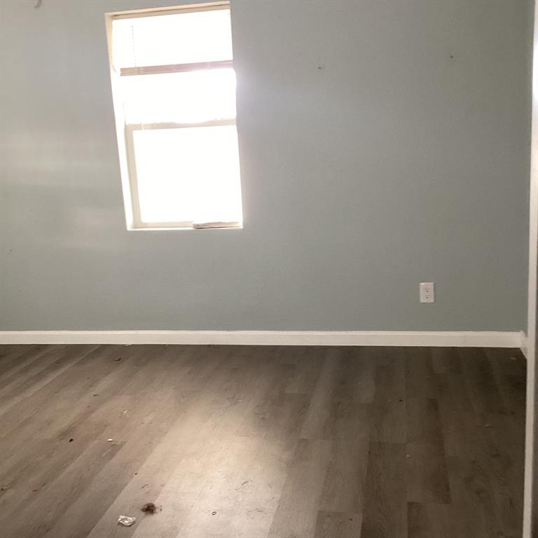 108 North Ash Street Springtown, TX 76082 - Photo 6 of 14 an empty room with a window