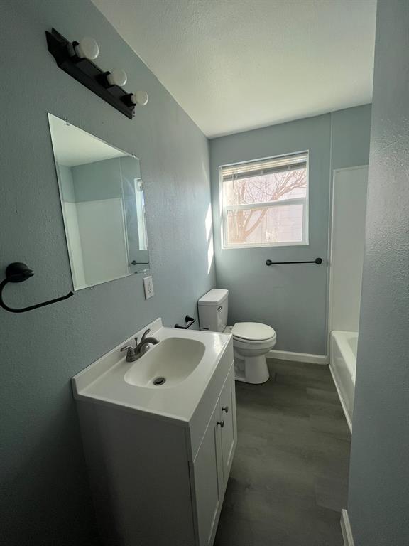 108 North Ash Street Springtown, TX 76082 - Photo 7 of 22 a bathroom with a sink and a toilet
