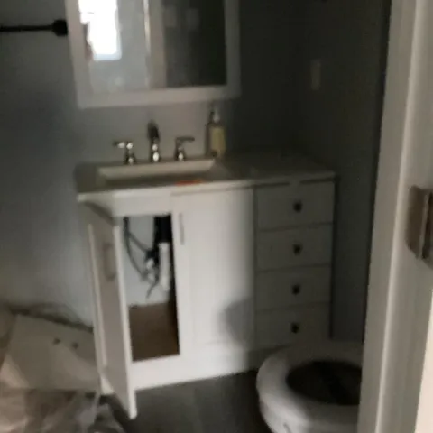 a bathroom with a sink and mirror