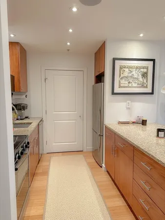 a spacious bathroom with a granite countertop sink a mirror and a bathtub