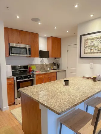 a kitchen with stainless steel appliances granite countertop a sink and a stove