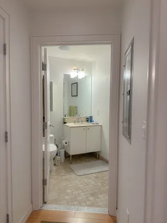 a bathroom with a tub mirror and toilet