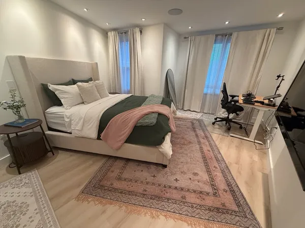 a bed room with a bed furniture and a large window