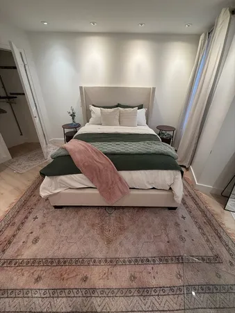 a bedroom with a bed and a rug