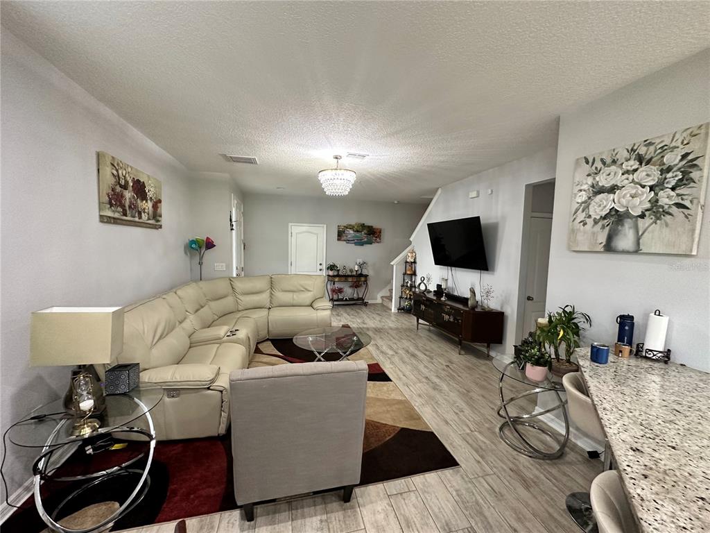 250 Rustic Loop Sanford, FL 32771 - Photo 3 of 33 a living room with furniture and a flat screen tv