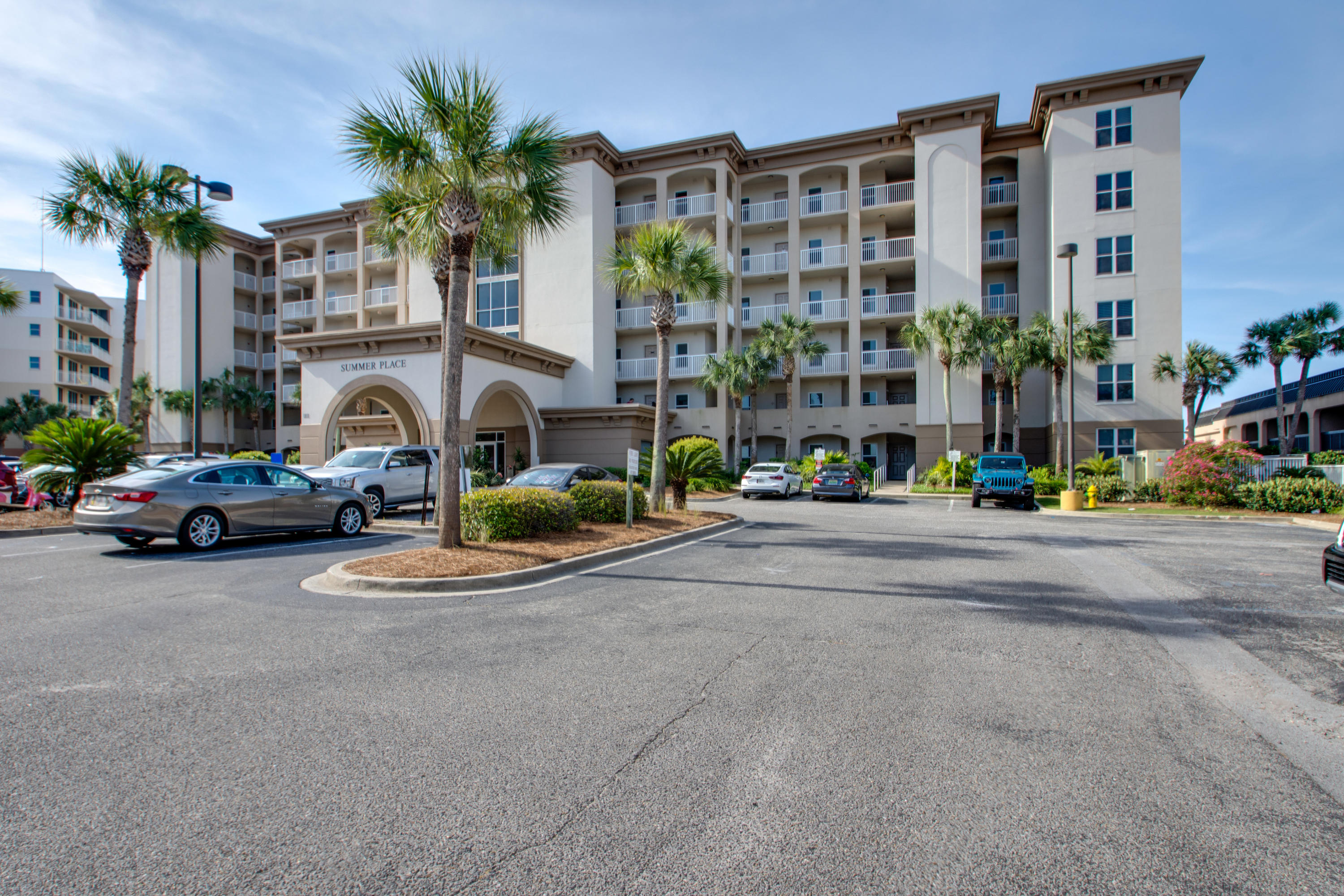 1111 Santa Rosa Boulevard, Unit 206 Fort Walton Beach, FL 32548 - Photo 2 of 46 a view of building with cars parked in front of it