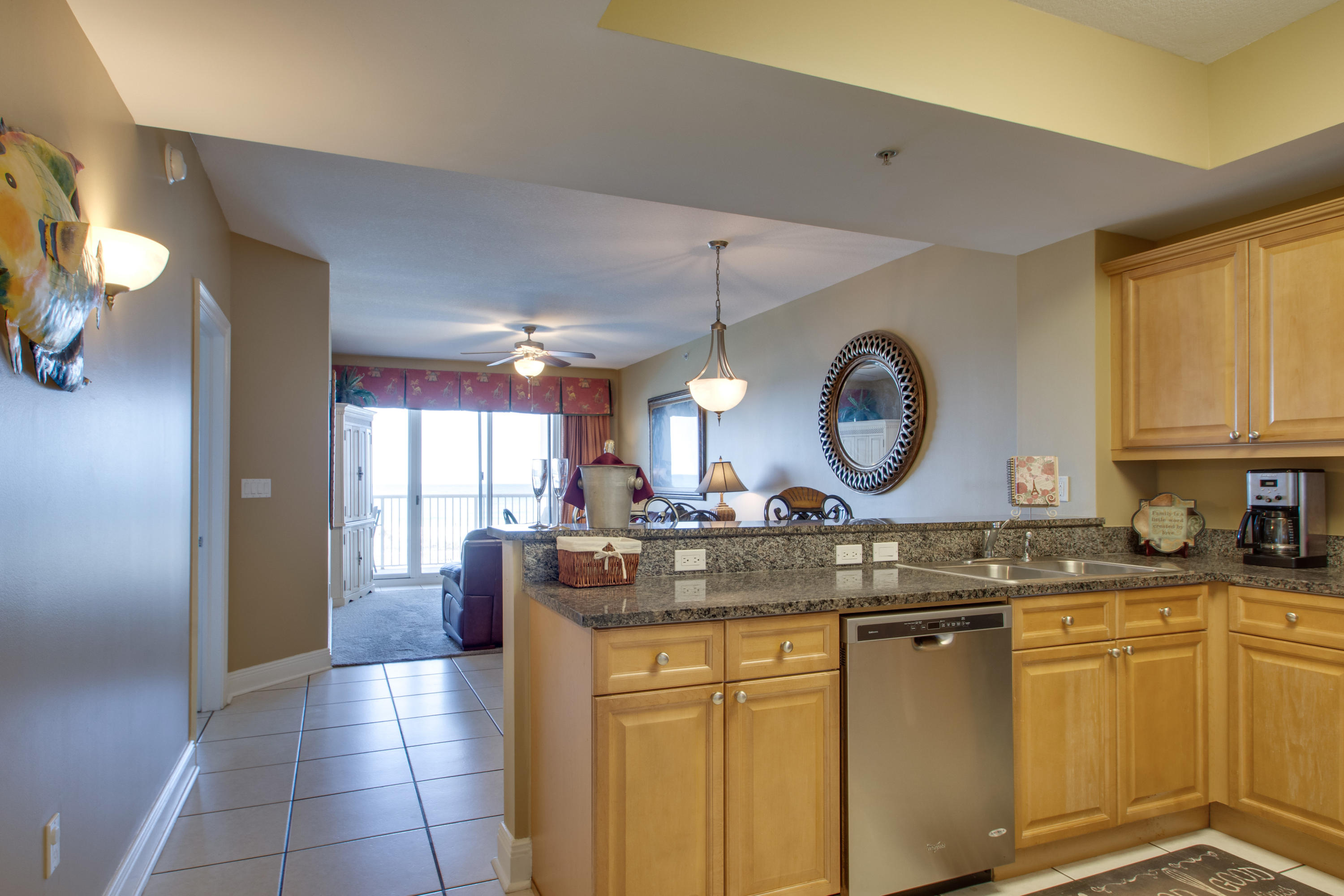 1111 Santa Rosa Boulevard, Unit 206 Fort Walton Beach, FL 32548 - Photo 5 of 46 a kitchen with granite countertop a sink a stove and cabinets