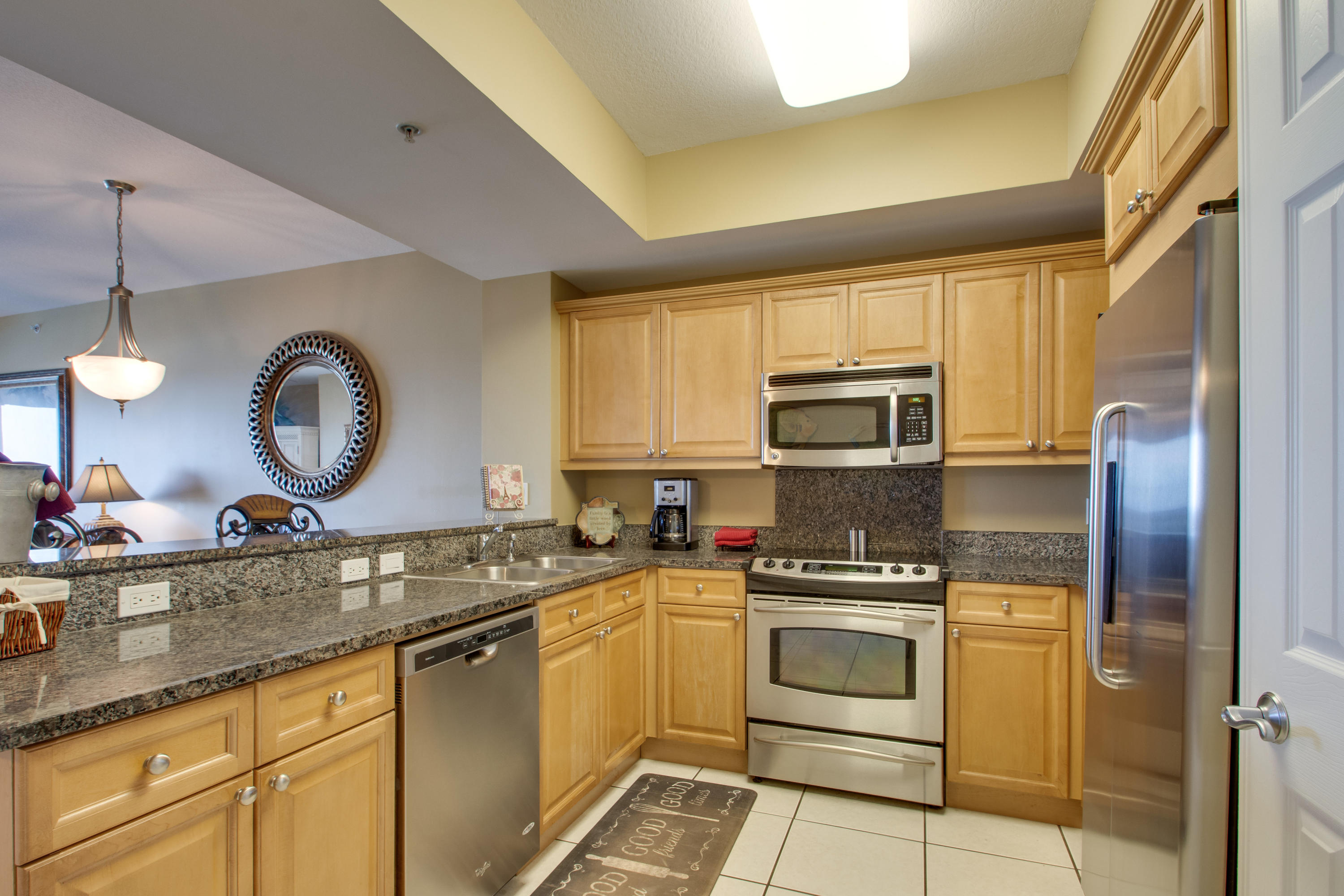 1111 Santa Rosa Boulevard, Unit 206 Fort Walton Beach, FL 32548 - Photo 6 of 46 a kitchen with granite countertop a sink stainless steel appliances and cabinets