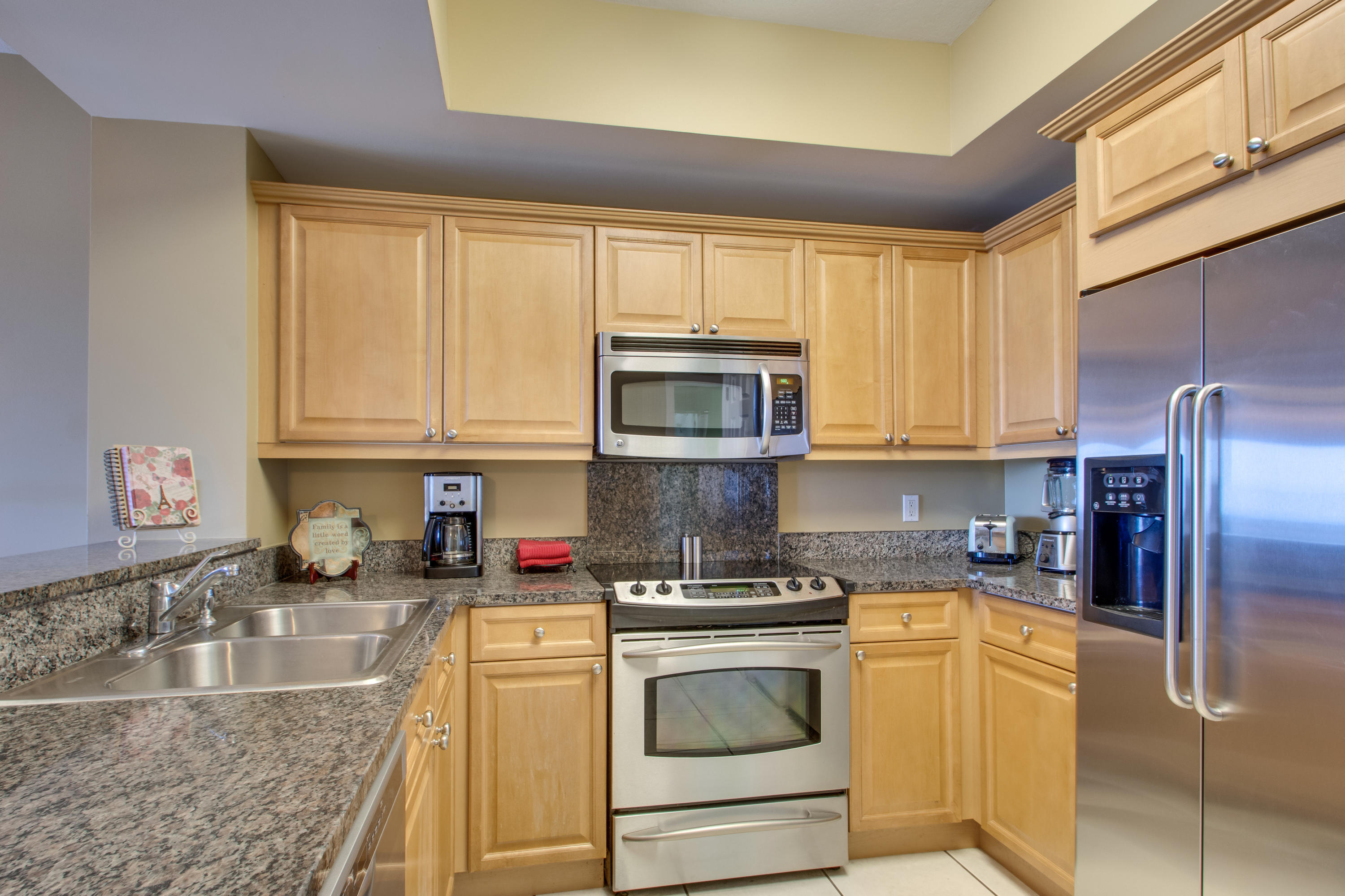 1111 Santa Rosa Boulevard, Unit 206 Fort Walton Beach, FL 32548 - Photo 7 of 46 a kitchen with stainless steel appliances granite countertop a sink stove and refrigerator