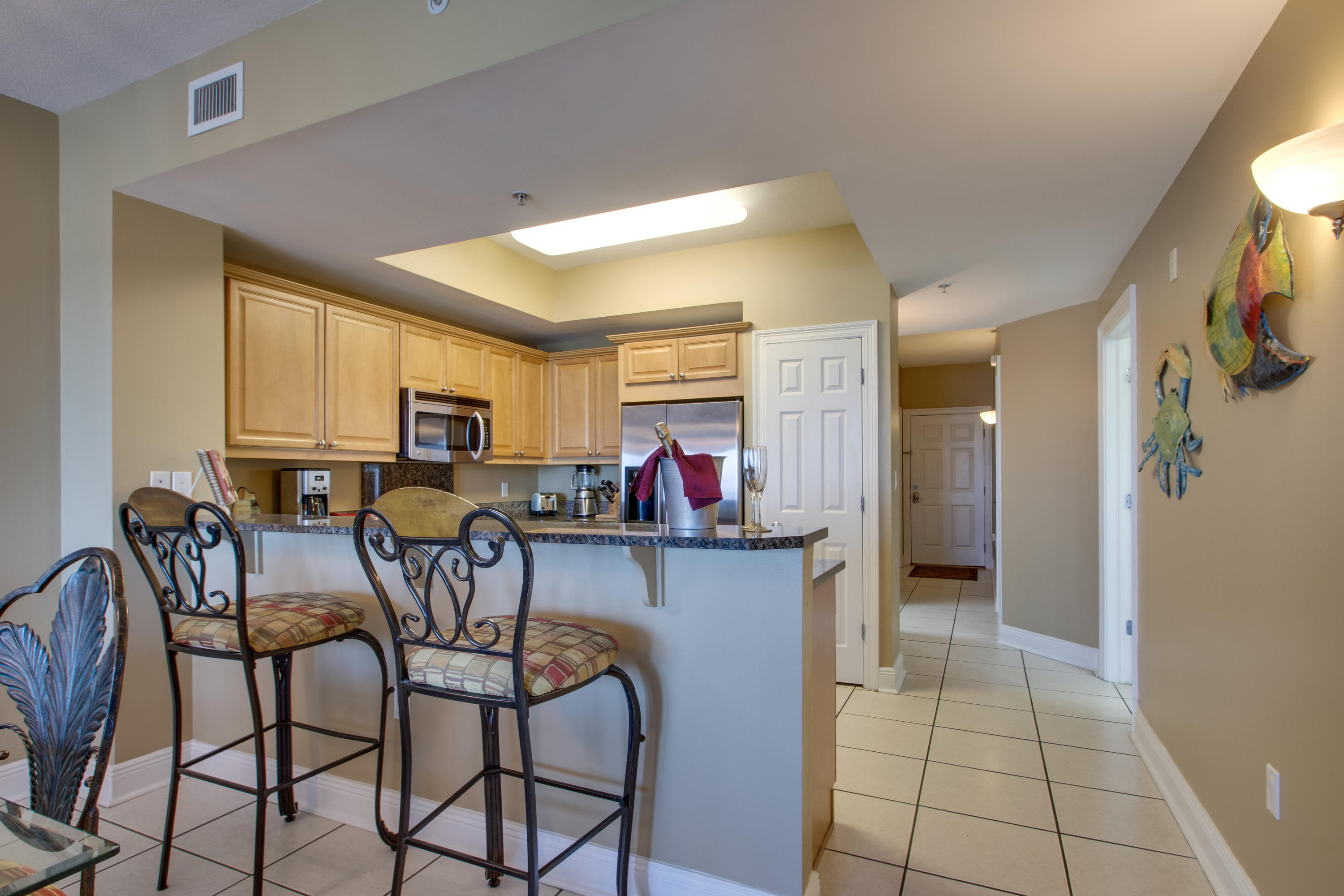 1111 Santa Rosa Boulevard, Unit 206 Fort Walton Beach, FL 32548 - Photo 8 of 46 a view of a dining room with furniture and a chandelier