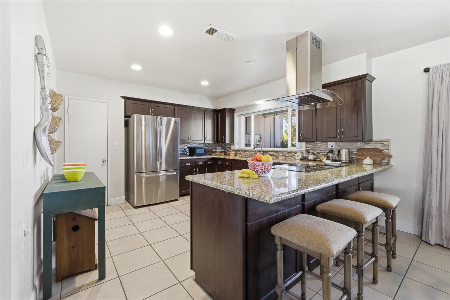 574 North Frankwood Avenue Reedley, CA 93654 - Photo 11 of 37 a kitchen with refrigerator and chairs