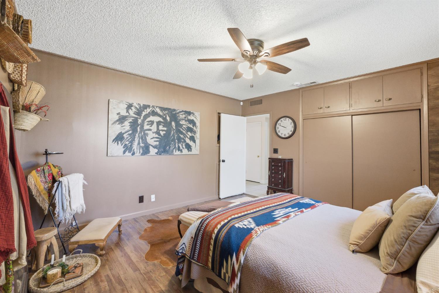 574 North Frankwood Avenue Reedley, CA 93654 - Photo 18 of 37 a bedroom with a bed and a chandelier