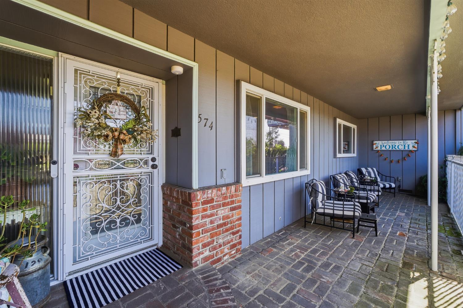 574 North Frankwood Avenue Reedley, CA 93654 - Photo 2 of 37 a balcony with furniture and wooden floor