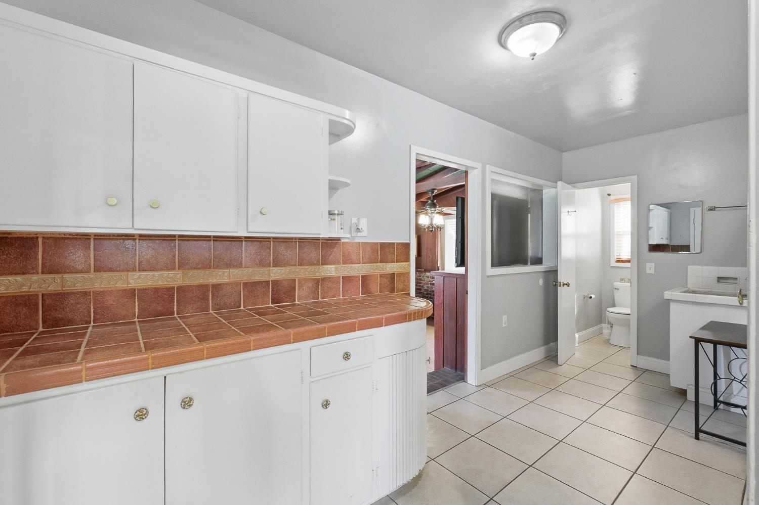 574 North Frankwood Avenue Reedley, CA 93654 - Photo 24 of 37 a kitchen with white cabinets and sink
