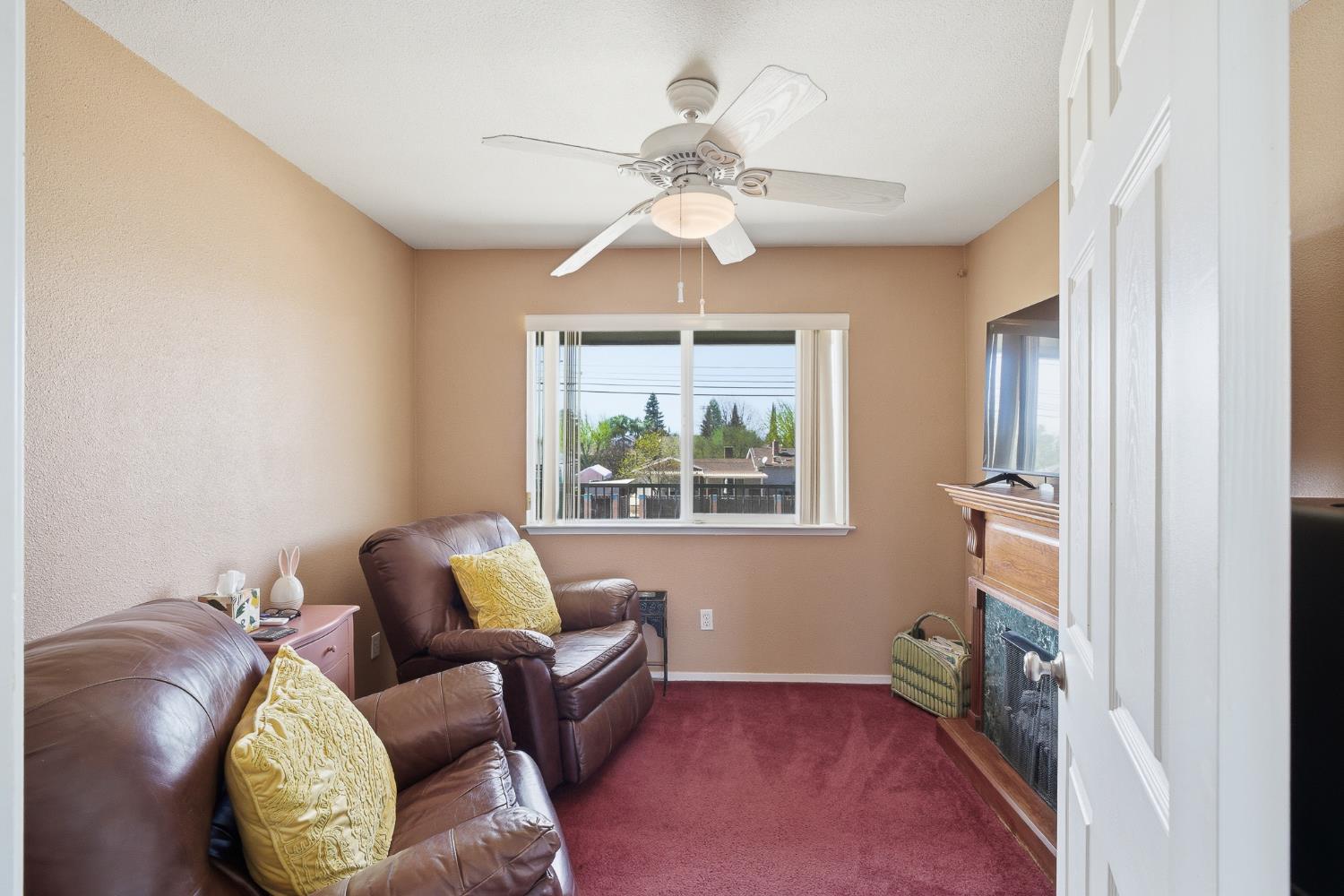 574 North Frankwood Avenue Reedley, CA 93654 - Photo 27 of 37 a living room with furniture and a chandelier