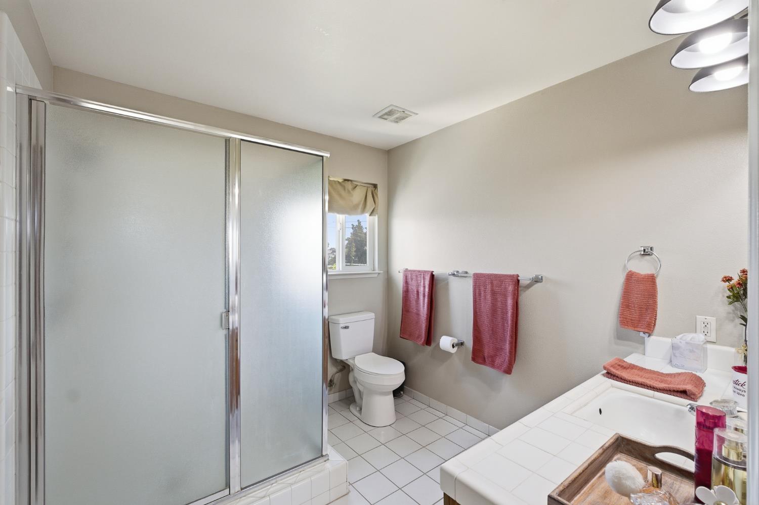 574 North Frankwood Avenue Reedley, CA 93654 - Photo 28 of 37 a bathroom with a toilet and a shower
