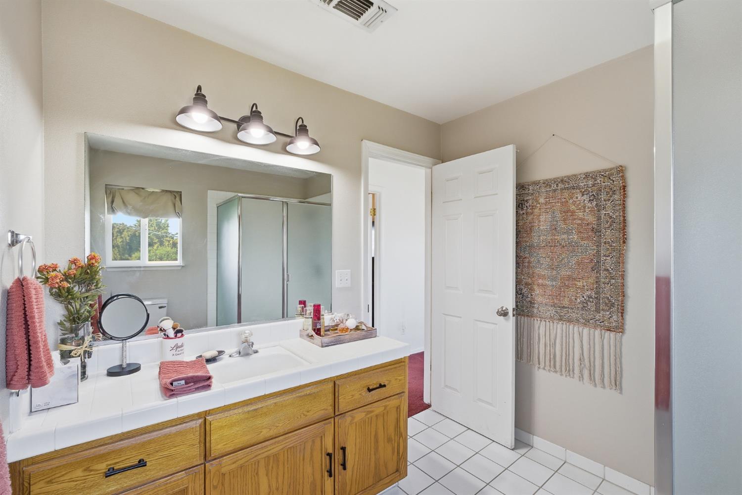 574 North Frankwood Avenue Reedley, CA 93654 - Photo 29 of 37 a bathroom with a double vanity sink and a mirror