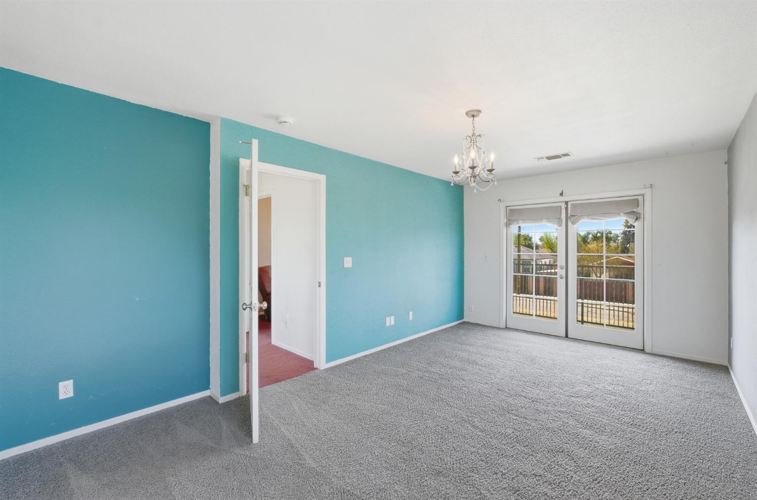 574 North Frankwood Avenue Reedley, CA 93654 - Photo 30 of 37 an empty room with chandelier fan and windows