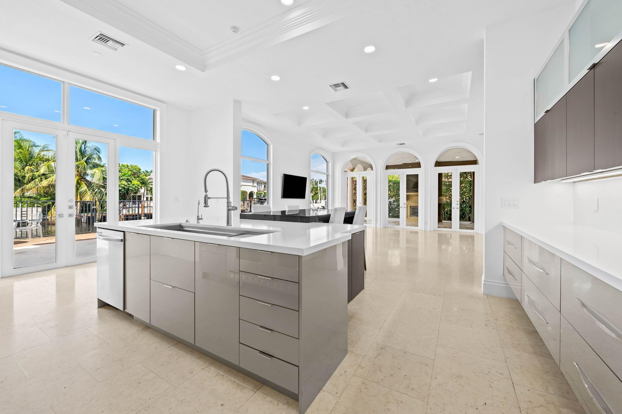 861 Nafa Drive Boca Raton, FL 33487 - Photo 26 of 58 a large white kitchen with kitchen island a large counter top space a sink a window and stainless steel appliances
