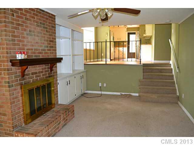 1447 McIlroy Road Charlotte, NC 28212 - Photo 12 of 12 a view of empty room with a fireplace and windows