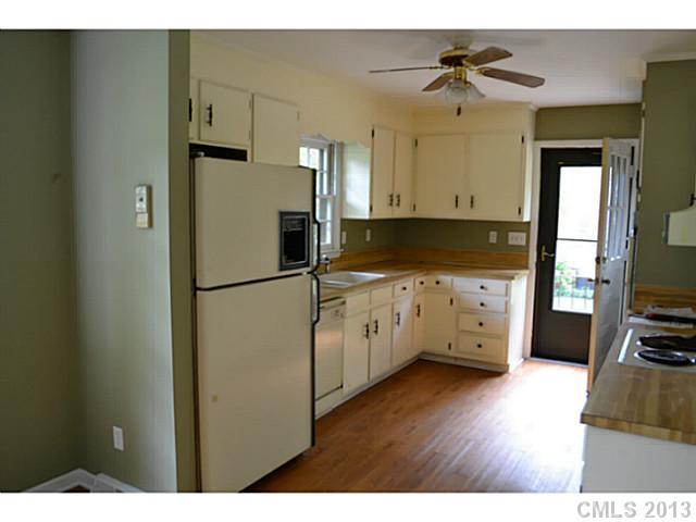 1447 McIlroy Road Charlotte, NC 28212 - Photo 4 of 12 a kitchen with stainless steel appliances a refrigerator sink and cabinets