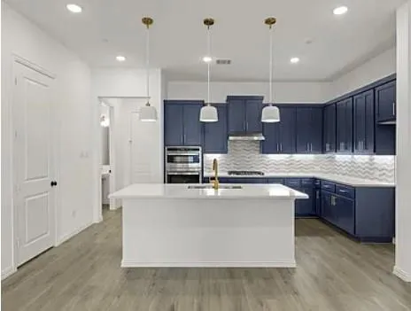 a view of kitchen with wooden floor and electronic appliances