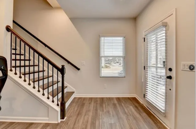 a view of an entryway with wooden floor and stairs